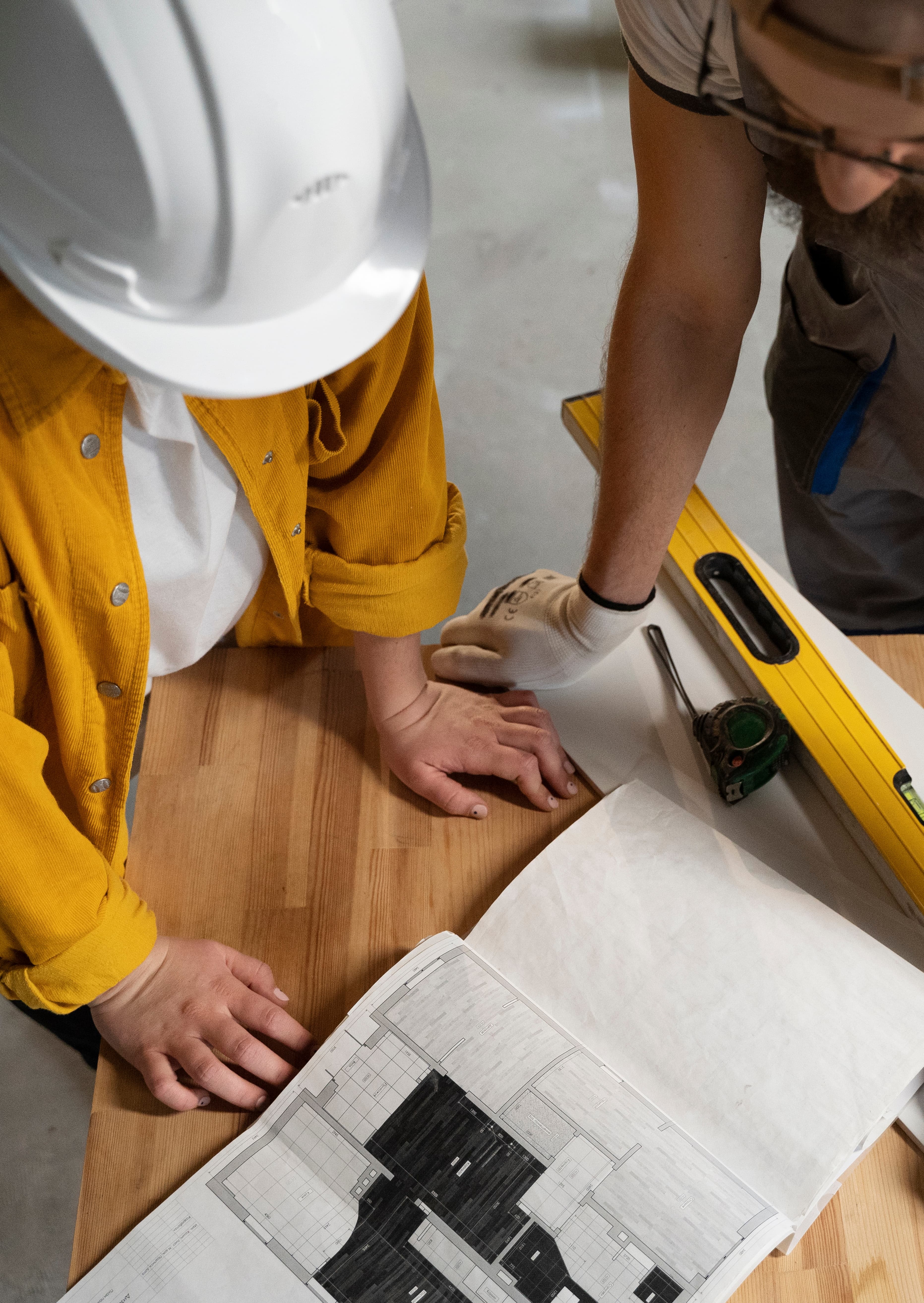 construction site with engineers reviewing blueprints